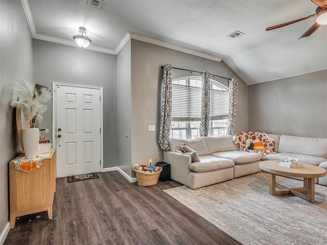 living room with lofted ceiling, ceiling fan, dark wood-type flooring, and ornamental molding