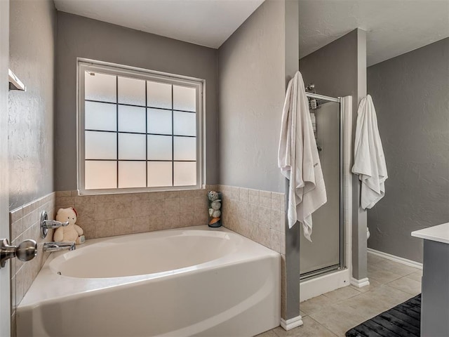 bathroom with tile patterned floors and separate shower and tub