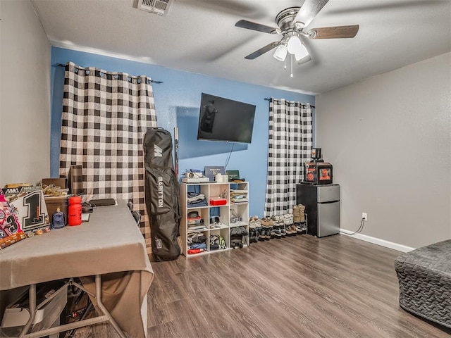 office space with ceiling fan and hardwood / wood-style flooring