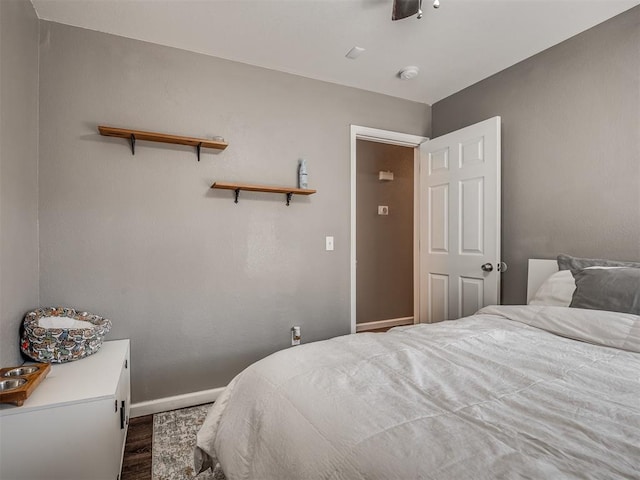 bedroom featuring ceiling fan and dark hardwood / wood-style flooring