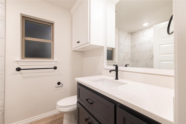9201 Lupine Rd, Yukon, OK 73099 - bathroom with vanity, toilet, wood finished floors, baseboards, and recessed lighting