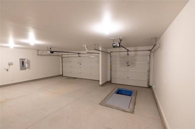 9201 Lupine Rd, Yukon, OK 73099 - garage featuring a garage door opener, electric panel, and baseboards