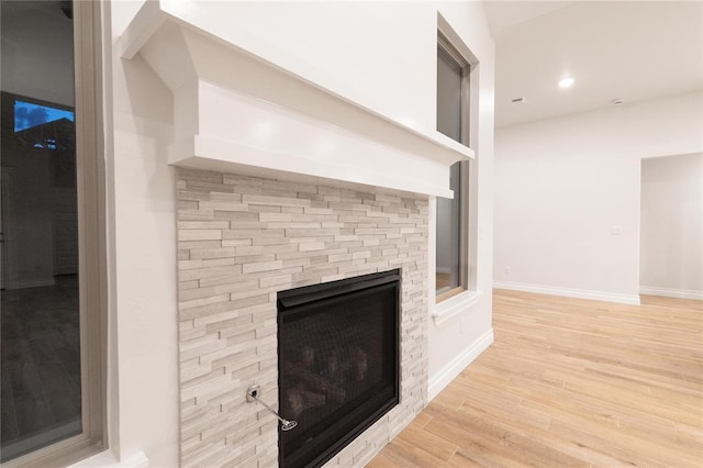 9201 Lupine Rd, Yukon, OK 73099 - detailed view of wood finished floors, a stone fireplace, baseboards, and recessed lighting