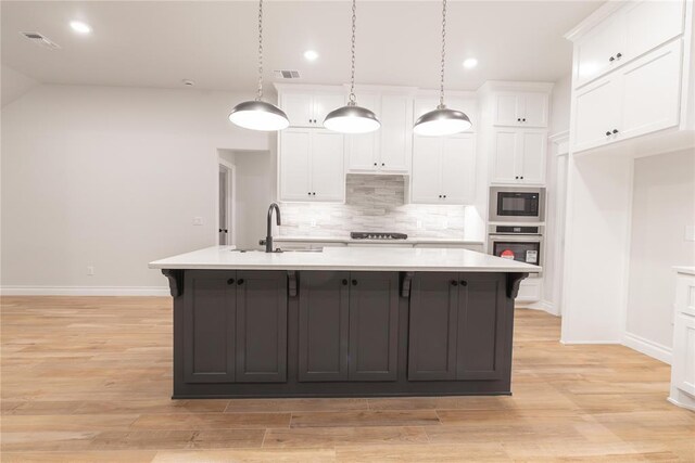 9201 Lupine Rd, Yukon, OK 73099 - kitchen with a sink, oven, built in microwave, decorative backsplash, and white cabinetry
