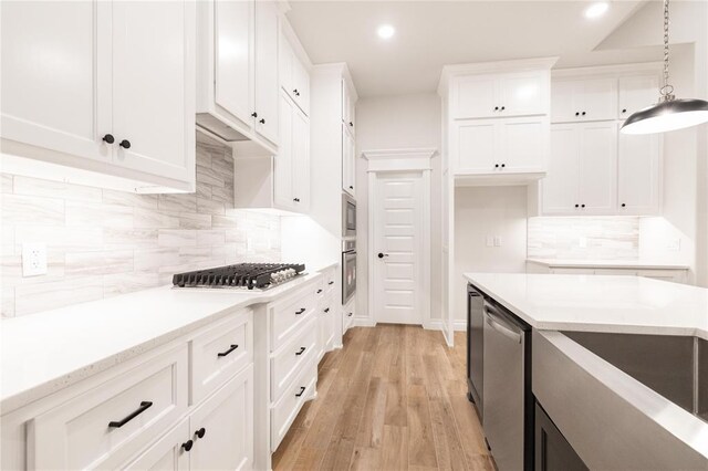 9201 Lupine Rd, Yukon, OK 73099 - kitchen with stainless steel appliances, white cabinets, backsplash, and recessed lighting