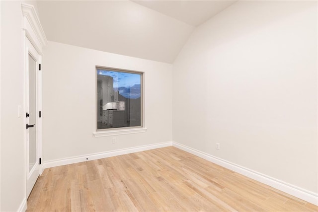 9201 Lupine Rd, Yukon, OK 73099 - empty room featuring light wood-style flooring, baseboards, and vaulted ceiling