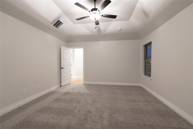 9201 Lupine Rd, Yukon, OK 73099 - spare room with a tray ceiling, light colored carpet, a ceiling fan, and baseboards