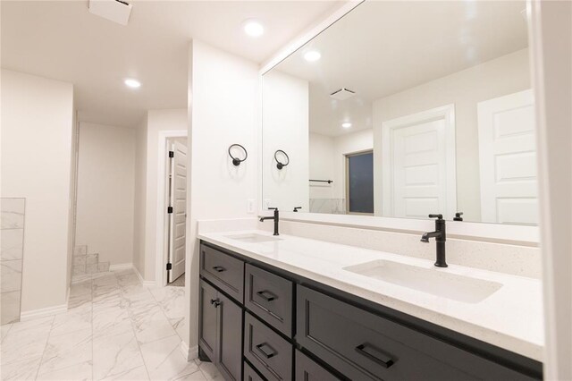 9201 Lupine Rd, Yukon, OK 73099 - bathroom with marble look tiles, double vanity, baseboards, and recessed lighting