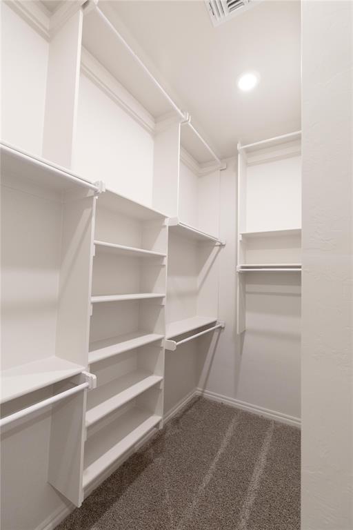9201 Lupine Rd, Yukon, OK 73099 - walk in closet featuring dark colored carpet