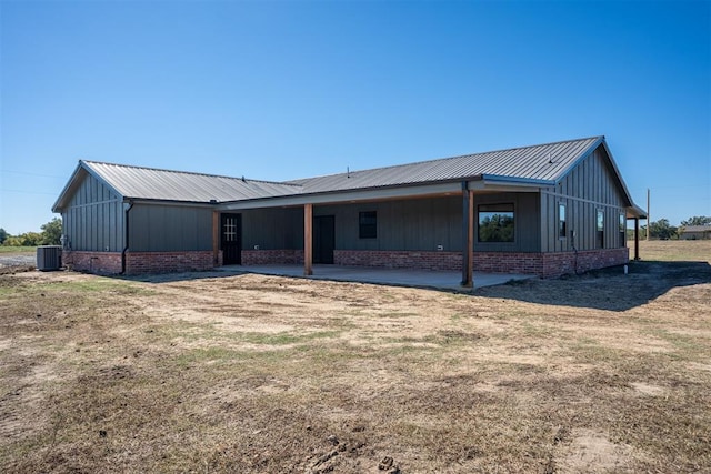 back of property with a lawn and cooling unit