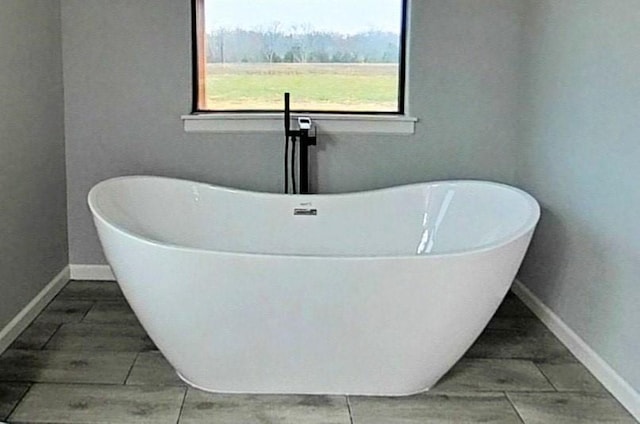 bathroom with a tub to relax in