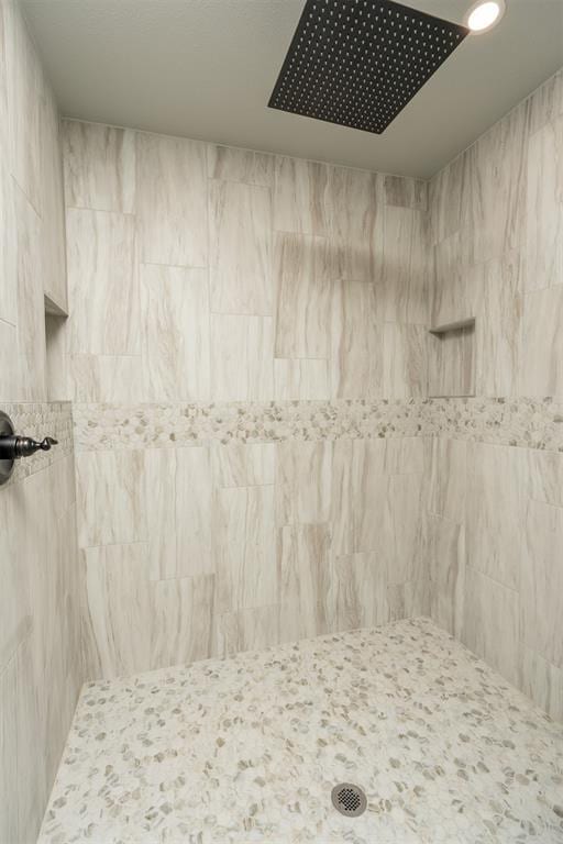 bathroom with tiled shower