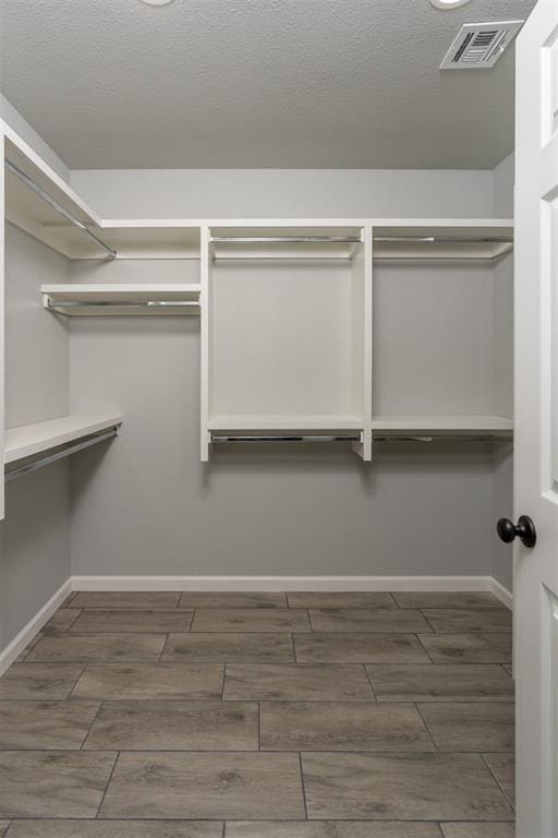 walk in closet featuring dark hardwood / wood-style flooring