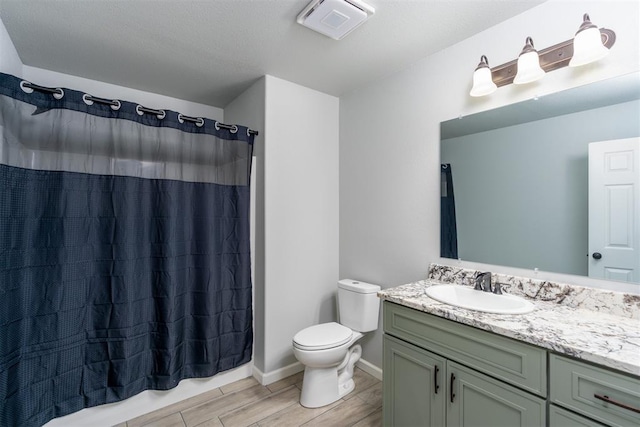 bathroom featuring vanity, curtained shower, toilet, and wood-type flooring