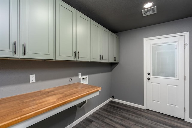 laundry area with dark hardwood / wood-style floors, cabinets, a textured ceiling, and hookup for a washing machine