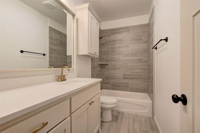 full bath with shower / bathtub combination, vanity, and toilet