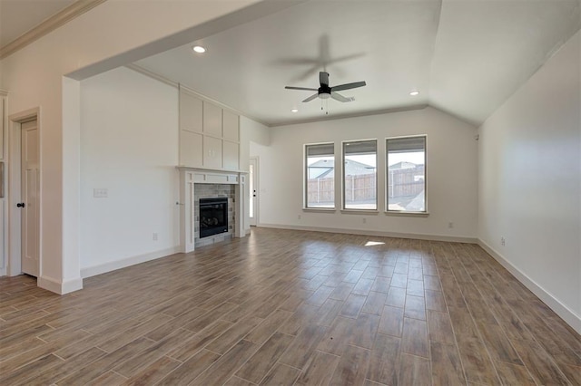 unfurnished living room featuring dark wood-style flooring, a fireplace, a ceiling fan, and baseboards