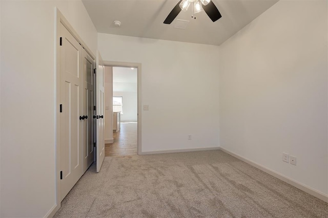 unfurnished room featuring ceiling fan, baseboards, and light colored carpet