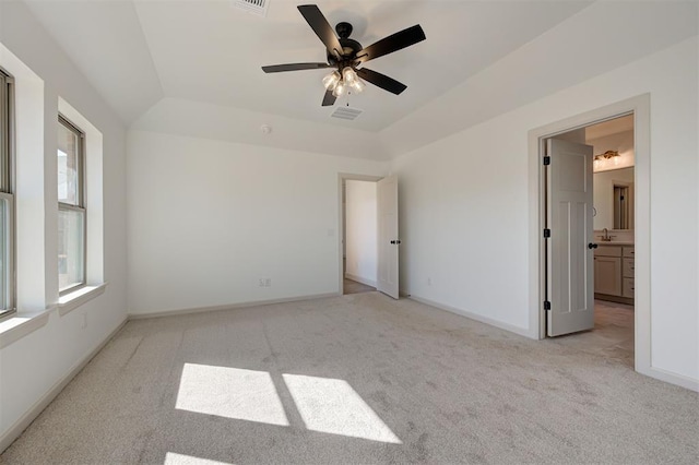 2216 Los Angeles Ave, Edmond, OK 73034 - unfurnished bedroom featuring light carpet, baseboards, lofted ceiling, connected bathroom, and a ceiling fan