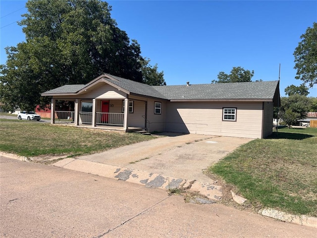 ranch-style house with covered porch and a front yard