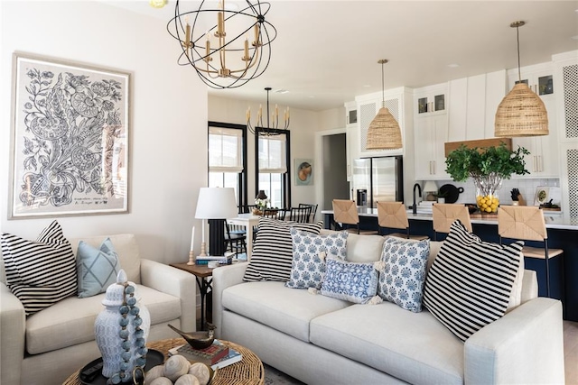 living room with sink and a notable chandelier