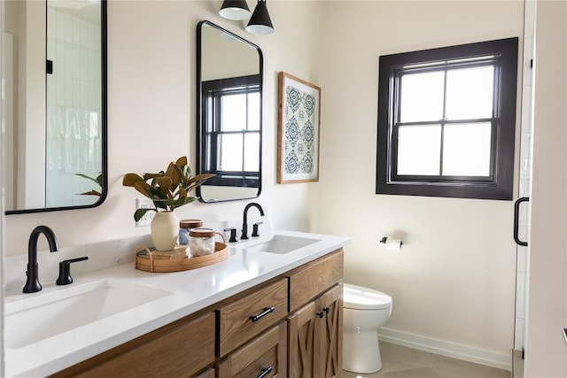 bathroom featuring tile patterned flooring, vanity, toilet, and a shower with door