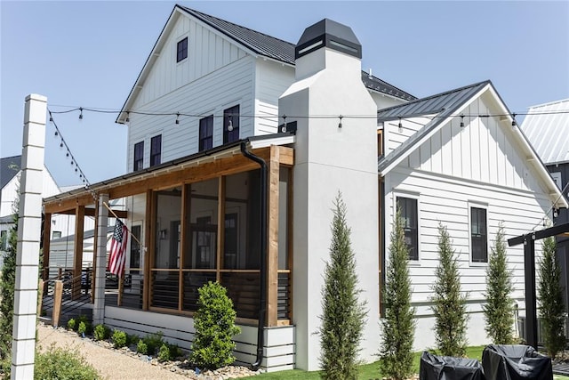 view of side of home featuring a sunroom