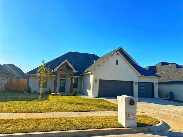 view of front of home featuring a garage and a front lawn