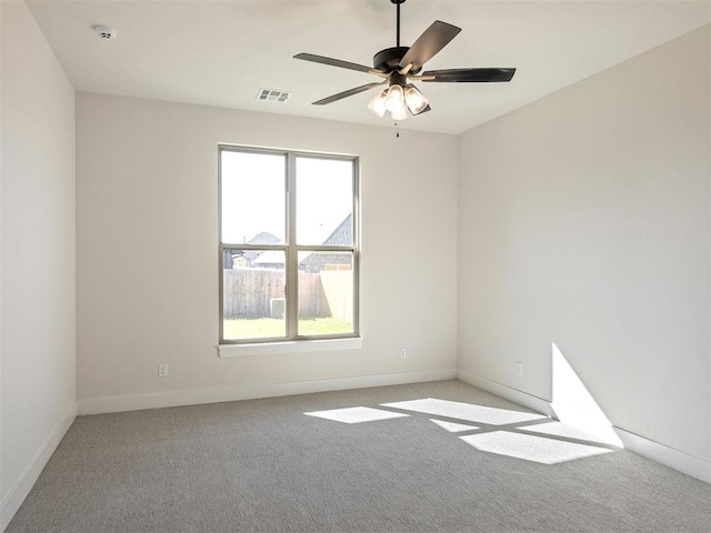 spare room featuring light carpet and ceiling fan