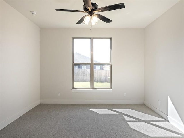 spare room featuring ceiling fan and light carpet