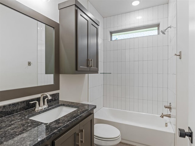 full bathroom with vanity, toilet, and tiled shower / bath