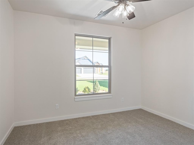 carpeted spare room featuring ceiling fan