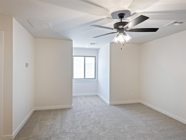 empty room with ceiling fan and light colored carpet