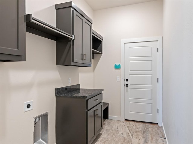 kitchen with gray cabinetry and dark stone countertops