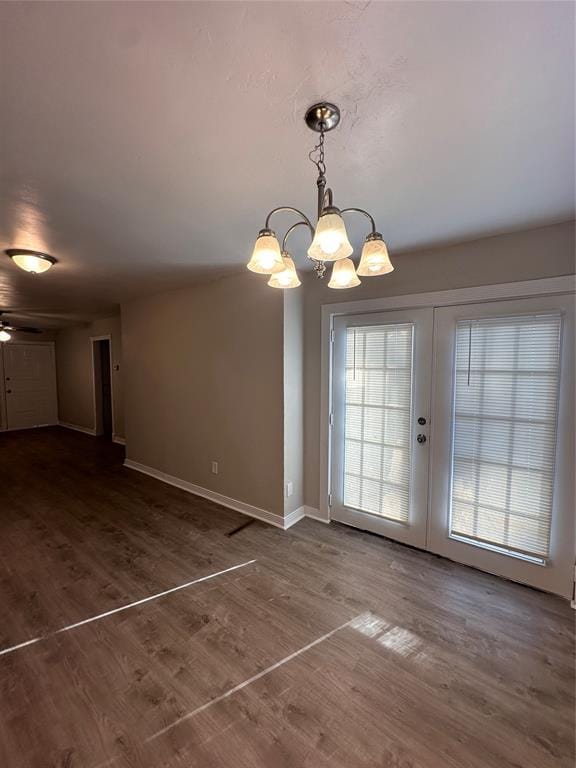 unfurnished dining area with a wealth of natural light, dark hardwood / wood-style flooring, and french doors