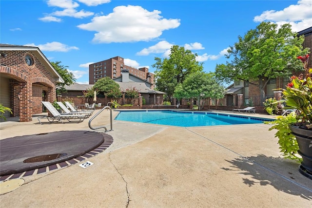 view of swimming pool featuring a patio area