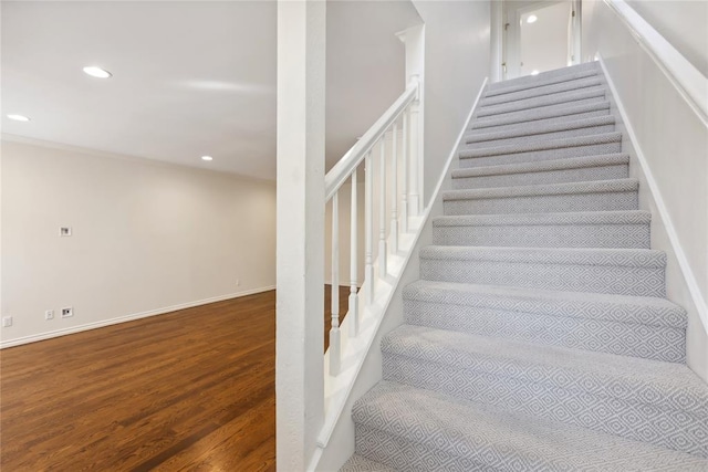 staircase with hardwood / wood-style flooring