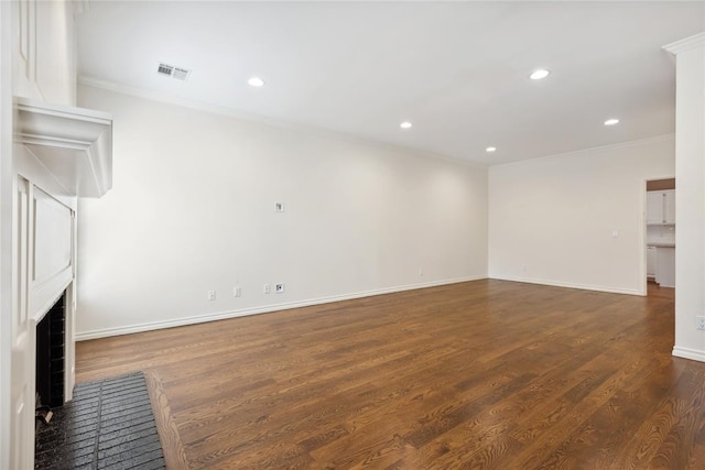 unfurnished living room featuring crown molding, dark wood-type flooring, and a brick fireplace