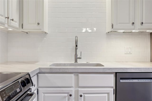 kitchen featuring backsplash, stainless steel dishwasher, sink, electric range, and white cabinetry