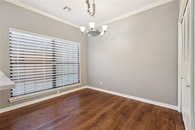 unfurnished dining area featuring ornamental molding, a notable chandelier, and hardwood / wood-style flooring