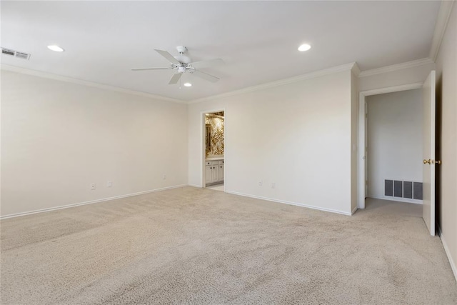 unfurnished room with ceiling fan, light colored carpet, and crown molding