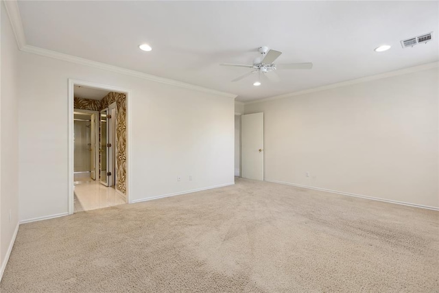 empty room with light colored carpet, ceiling fan, and ornamental molding