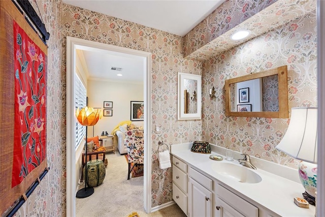 bathroom featuring crown molding and vanity