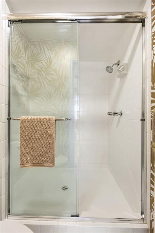 bathroom featuring a shower with shower door