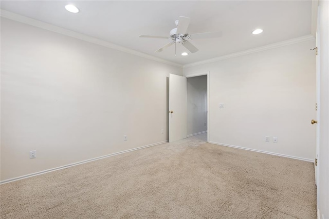 unfurnished room featuring crown molding, carpet floors, and ceiling fan