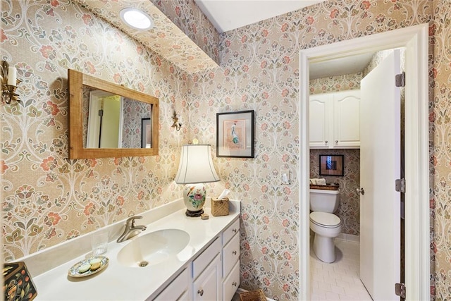 bathroom with tile patterned floors, vanity, and toilet