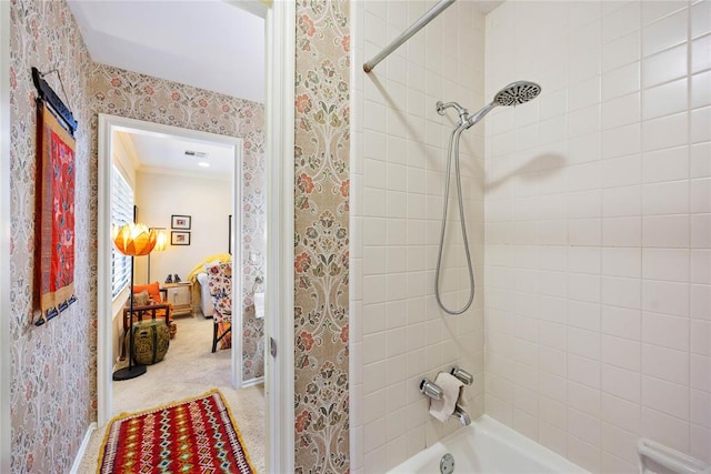 bathroom featuring tiled shower / bath combo and crown molding