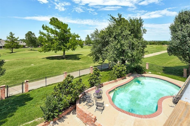 view of swimming pool featuring a patio area and a yard