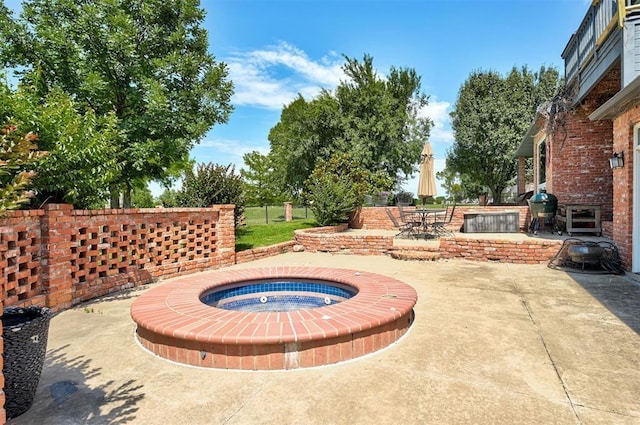 view of patio featuring an in ground hot tub and grilling area