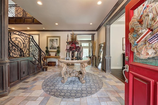 entryway featuring crown molding and decorative columns